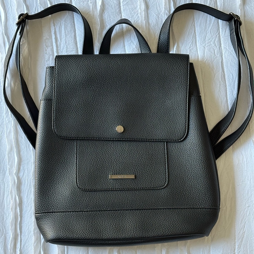 black Uncle K leather backpack adjustable straps and a front flap closure.